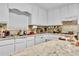Kitchen boasts white cabinets, granite countertops, and ample counter space at 5833 Wind Haven Nw Ct, Kennesaw, GA 30152