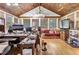 Sunroom office with wood ceiling, hardwood floors, and ample workspace at 5833 Wind Haven Nw Ct, Kennesaw, GA 30152