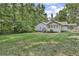 Spacious backyard with grassy area and home view at 5833 Wind Haven Nw Ct, Kennesaw, GA 30152
