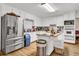 Bright kitchen with white cabinets, stainless steel appliances, and an island at 5833 Wind Haven Nw Ct, Kennesaw, GA 30152