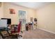 Home office with a desk, red office chair, and carpeted floors at 2641 Short Trl, Lithia Springs, GA 30122