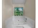 Bathroom with corner bathtub and window at 4024 Waldrop Hills Dr, Decatur, GA 30034