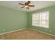 Light green walls and beige carpet in this bright bedroom with ceiling fan at 3637 Kelsey Chase Ct, Marietta, GA 30060