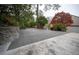 Large concrete patio with stone retaining wall and landscaping at 1617 Lenox Rd, Atlanta, GA 30306