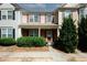 Two-story townhome with brick and siding exterior, landscaping, and a walkway at 3006 Deerborne Ct, Atlanta, GA 30331