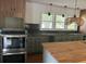 Modern kitchen with dark tile backsplash and wood cabinets at 2381 County Line Sw Rd, Atlanta, GA 30331