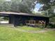 Ranch style home with black brick exterior and deck at 2381 County Line Sw Rd, Atlanta, GA 30331