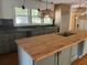 Modern kitchen with wood island and green cabinets at 2381 County Line Sw Rd, Atlanta, GA 30331