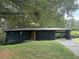 Ranch style home with black brick exterior, carport and landscaped yard at 2381 County Line Sw Rd, Atlanta, GA 30331