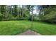 Large grassy backyard with a wooden post at 4169 Panola Lake Cir, Lithonia, GA 30038