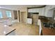 White kitchen with tile floors, and a stone accent wall at 4169 Panola Lake Cir, Lithonia, GA 30038