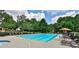 Community swimming pool with lounge chairs and umbrellas at 738 Key Largo Ct, Auburn, GA 30011