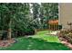 Landscaped backyard with tiered deck and lush greenery at 738 Key Largo Ct, Auburn, GA 30011