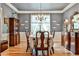 Formal dining room with chandelier, hardwood floors, and antique furniture at 738 Key Largo Ct, Auburn, GA 30011