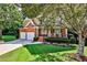 Landscaped front yard with lush green grass and mature trees at 738 Key Largo Ct, Auburn, GA 30011