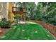 Large backyard with deck, patio, and wooden fence. Lush green grass at 738 Key Largo Ct, Auburn, GA 30011