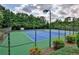 Two lighted tennis courts with green and blue surface at 738 Key Largo Ct, Auburn, GA 30011