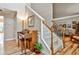 Elegant staircase with hardwood floors and a piano in the foyer at 738 Key Largo Ct, Auburn, GA 30011