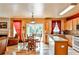 Open concept kitchen and dining area with hardwood floors and access to a deck at 738 Key Largo Ct, Auburn, GA 30011