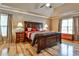 Spacious main bedroom with king-size bed and hardwood floors at 738 Key Largo Ct, Auburn, GA 30011