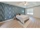Bright bedroom with stylish geometric wallpaper and wood-look flooring at 388 Oakhaven Way, Villa Rica, GA 30180