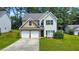 Two-story house with a double garage and a well-maintained lawn at 388 Oakhaven Way, Villa Rica, GA 30180