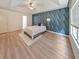 Bedroom with wall-to-wall geometric patterned wallpaper and light wood flooring at 388 Oakhaven Way, Villa Rica, GA 30180