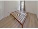 Simple bedroom with wood platform bed and large window at 388 Oakhaven Way, Villa Rica, GA 30180