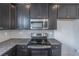 Modern kitchen with stainless steel appliances and granite countertops at 7745 Squire Ct, Fairburn, GA 30213