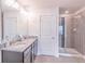 Modern bathroom featuring double sinks, granite countertops, and a walk-in shower at 7745 Squire Ct, Fairburn, GA 30213