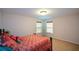 Bedroom with a queen bed and two windows at 2413 Mcintosh Dr, Locust Grove, GA 30248