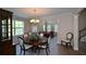 Bright dining room with hardwood floors and a view to the living room at 2413 Mcintosh Dr, Locust Grove, GA 30248