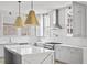 Modern kitchen with white cabinets, marble island, and gold lighting at 100 Ottley Ln, Atlanta, GA 30305