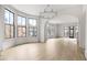 Large living area with hardwood floors, arched entryways, and multiple windows at 100 Ottley Ln, Atlanta, GA 30305
