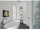 Spa-like bathroom featuring a soaking tub, built-in shelving, and a walk-in shower at 100 Ottley Ln, Atlanta, GA 30305