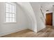 Bright hallway featuring hardwood floors and a wooden door at 100 Ottley Ln, Atlanta, GA 30305