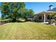 Green backyard with covered patio and trees at 1001 S Creek Dr, Villa Rica, GA 30180