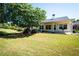 Spacious backyard with large trees and covered patio at 1001 S Creek Dr, Villa Rica, GA 30180