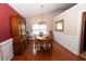 Formal dining room featuring hardwood floors, crown molding, and a charming chandelier at 1001 S Creek Dr, Villa Rica, GA 30180