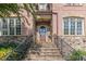 Brick front entry with stone accents, arched door, and wrought iron railings at 1829 Buckhead Valley Ne Ln, Atlanta, GA 30324