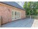 Deck scene adjacent to brick home featuring french doors leading inside at 1829 Buckhead Valley Ne Ln, Atlanta, GA 30324