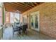 Spacious covered deck with brick wall and outdoor furniture at 1829 Buckhead Valley Ne Ln, Atlanta, GA 30324