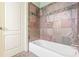 Bathroom with a tub and updated tile surround at 1829 Buckhead Valley Ne Ln, Atlanta, GA 30324