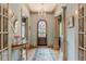 Grand entryway with arched door, hardwood floors, and a decorative console table at 1829 Buckhead Valley Ne Ln, Atlanta, GA 30324