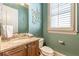 Stylish powder room with granite countertop, wood cabinets, and decorative wall art at 1829 Buckhead Valley Ne Ln, Atlanta, GA 30324