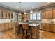 Eat-in kitchen boasts an island with seating, stainless steel appliances, and hardwood floors at 1829 Buckhead Valley Ne Ln, Atlanta, GA 30324