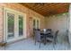 Covered deck features a table and chairs, and brick exterior at 1829 Buckhead Valley Ne Ln, Atlanta, GA 30324