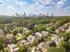Aerial view of a luxury home community with city skyline in the background at 1829 Buckhead Valley Ne Ln, Atlanta, GA 30324