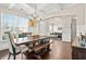 Bright dining room with hardwood floors, a large table, and views into the living room at 5107 Fellowship Dr, Buford, GA 30519