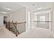 Upstairs hallway with wood railing and carpet at 5107 Fellowship Dr, Buford, GA 30519